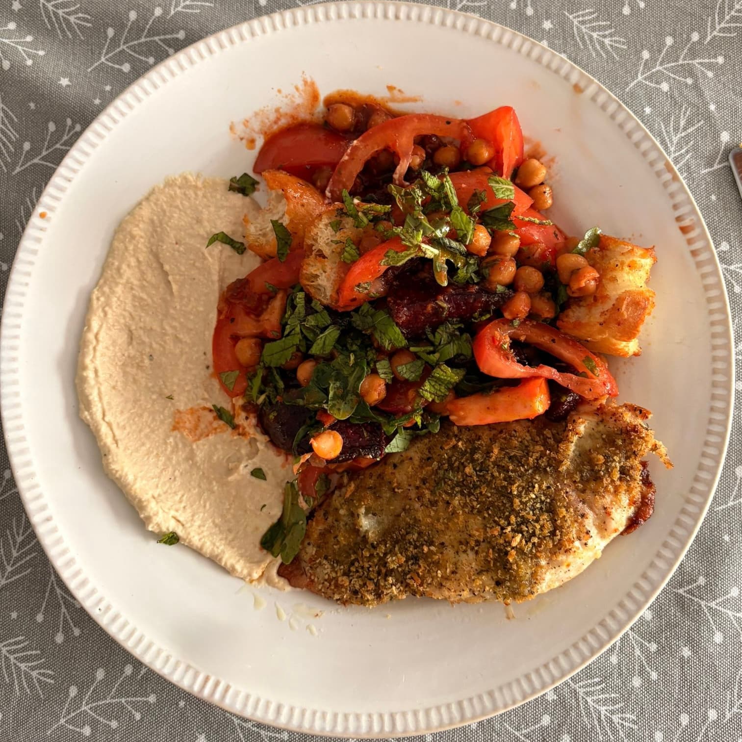 Mediterranean style tomato and chickpea salad, breaded chicken breast and a healthy dollop of hummus